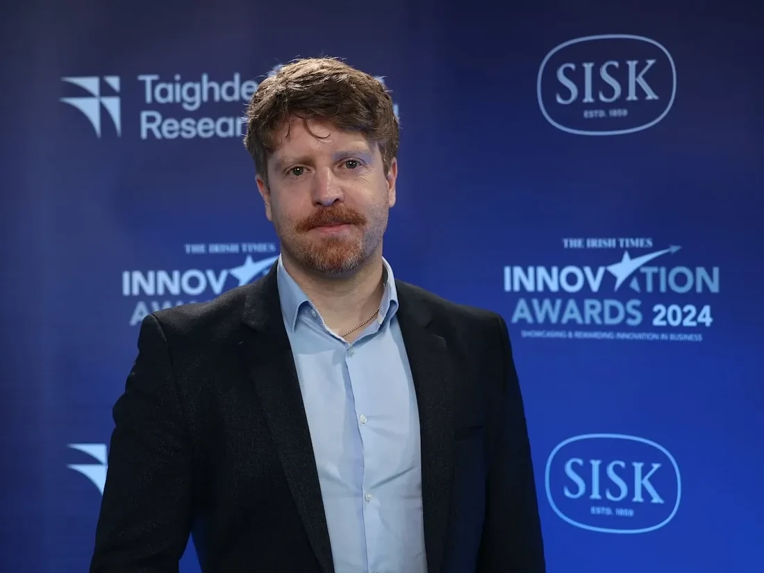 A member of the EpiSensor team in front of the press wall at The Irish Times Innovation Awards 2024.