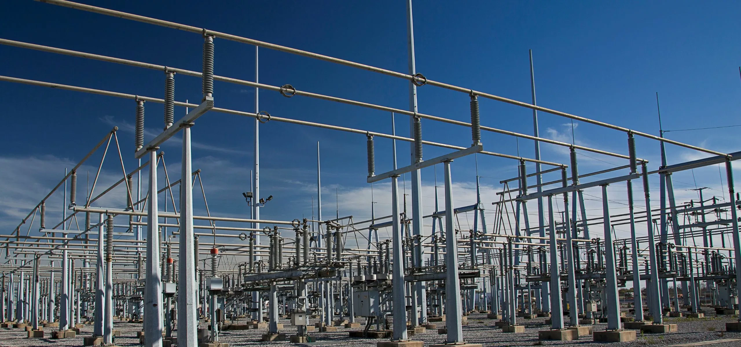 Steel gantries and busbars inside an electrical substation.