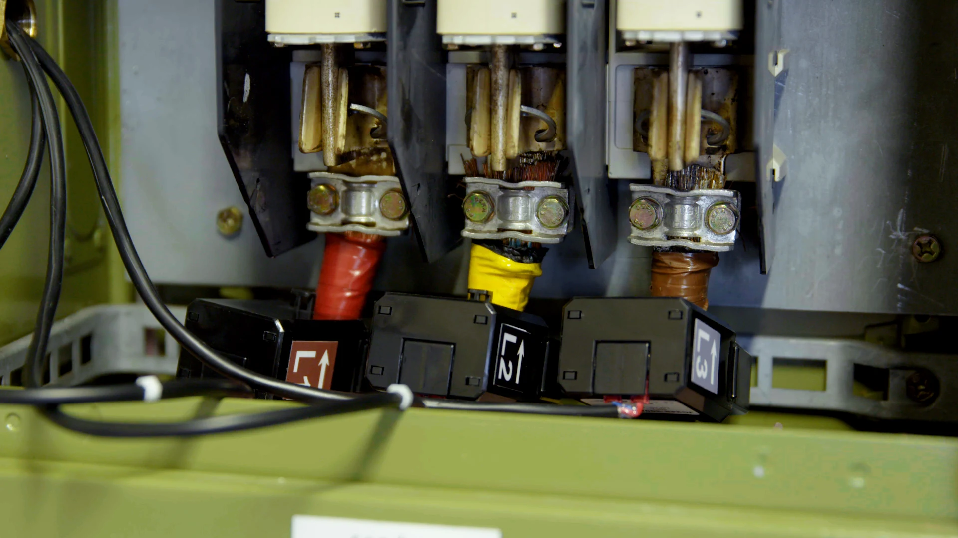 Three current transformers installed around the L1, L2 and L3 conductors in a distribution board.