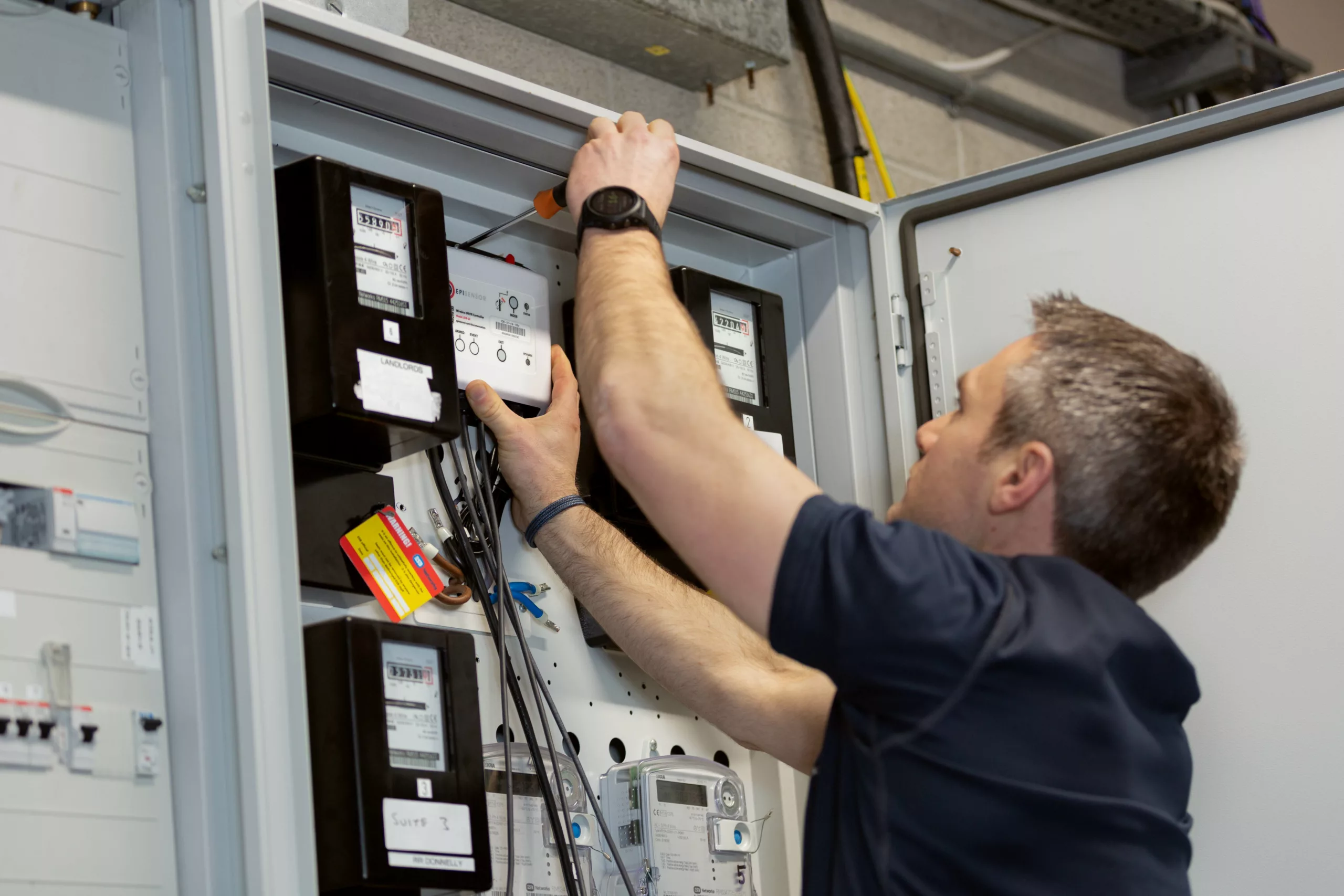 EpiSensor engineer installing wireless monitoring hardware