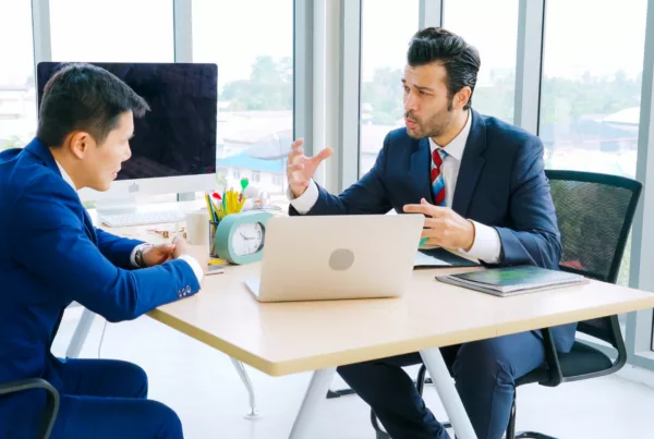 Two-people-at-desk-meeting-blue-planet-getty-images-via-CANVA